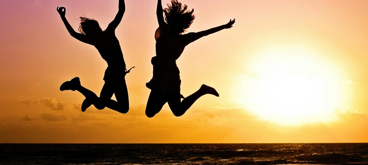 silhouette photography of jump shot of two persons